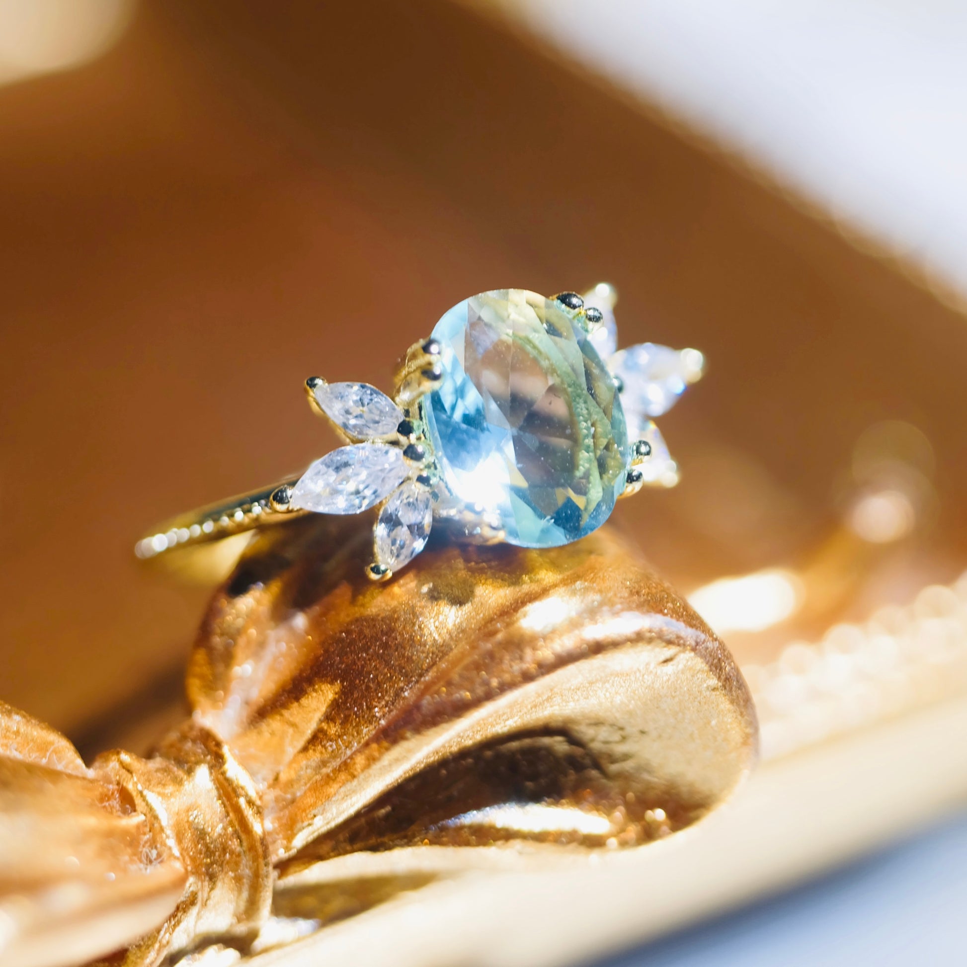 Adjustable blue topaz wing ring by STAR WISH featuring a detailed wing design and vibrant blue gemstone on a silver band.