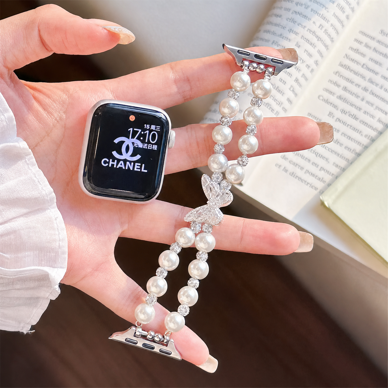 Pearl butterfly Apple Watch band in hand