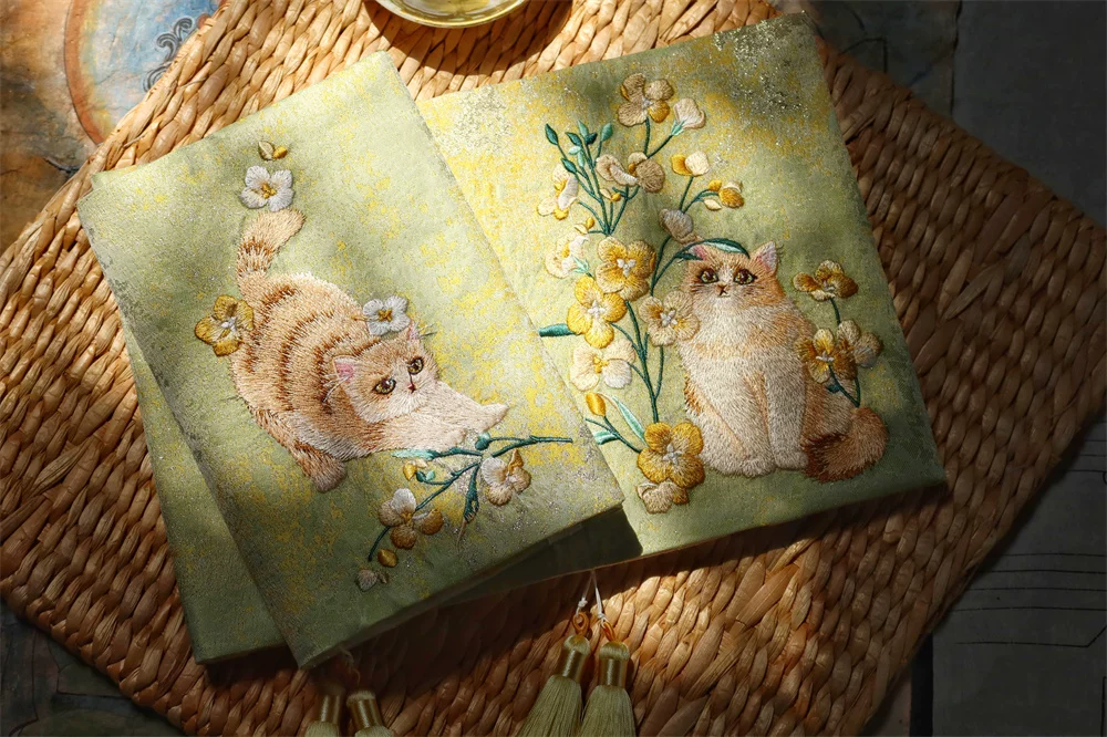 Handmade garden-themed cat embroidered journal by STAR WISH with floral embroidery and lined pages for writing.