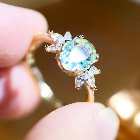 Adjustable blue topaz wing ring by STAR WISH featuring a detailed wing design and vibrant blue gemstone setting.