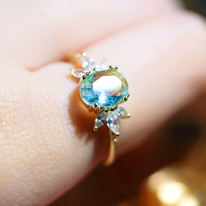 STAR WISH adjustable blue topaz wing ring showing a silver band with a detailed blue topaz wing design.