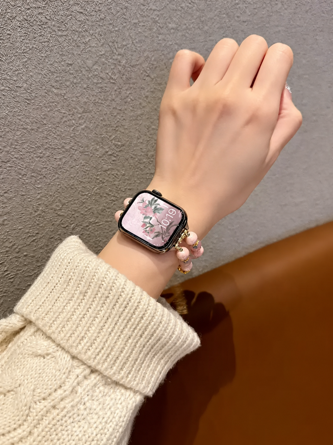Pink beaded woven Apple Watch band on wrist