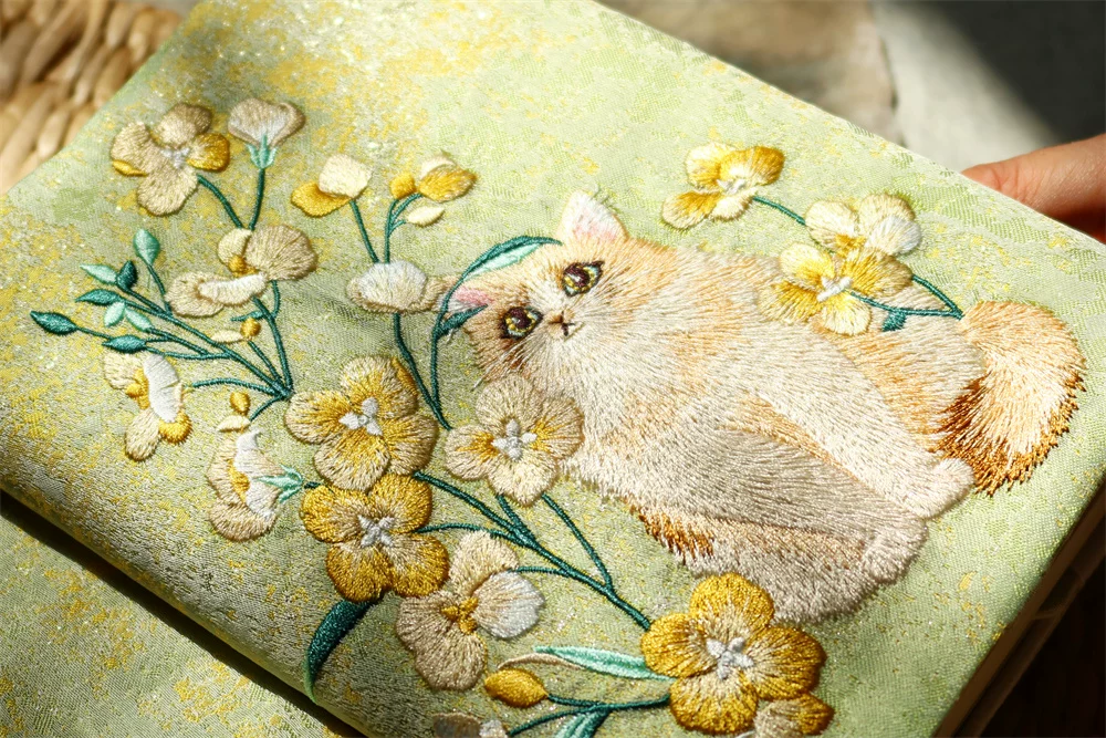 Handmade garden-themed embroidered journal by STAR WISH featuring cat design and floral details, perfect for writing or sketching.
