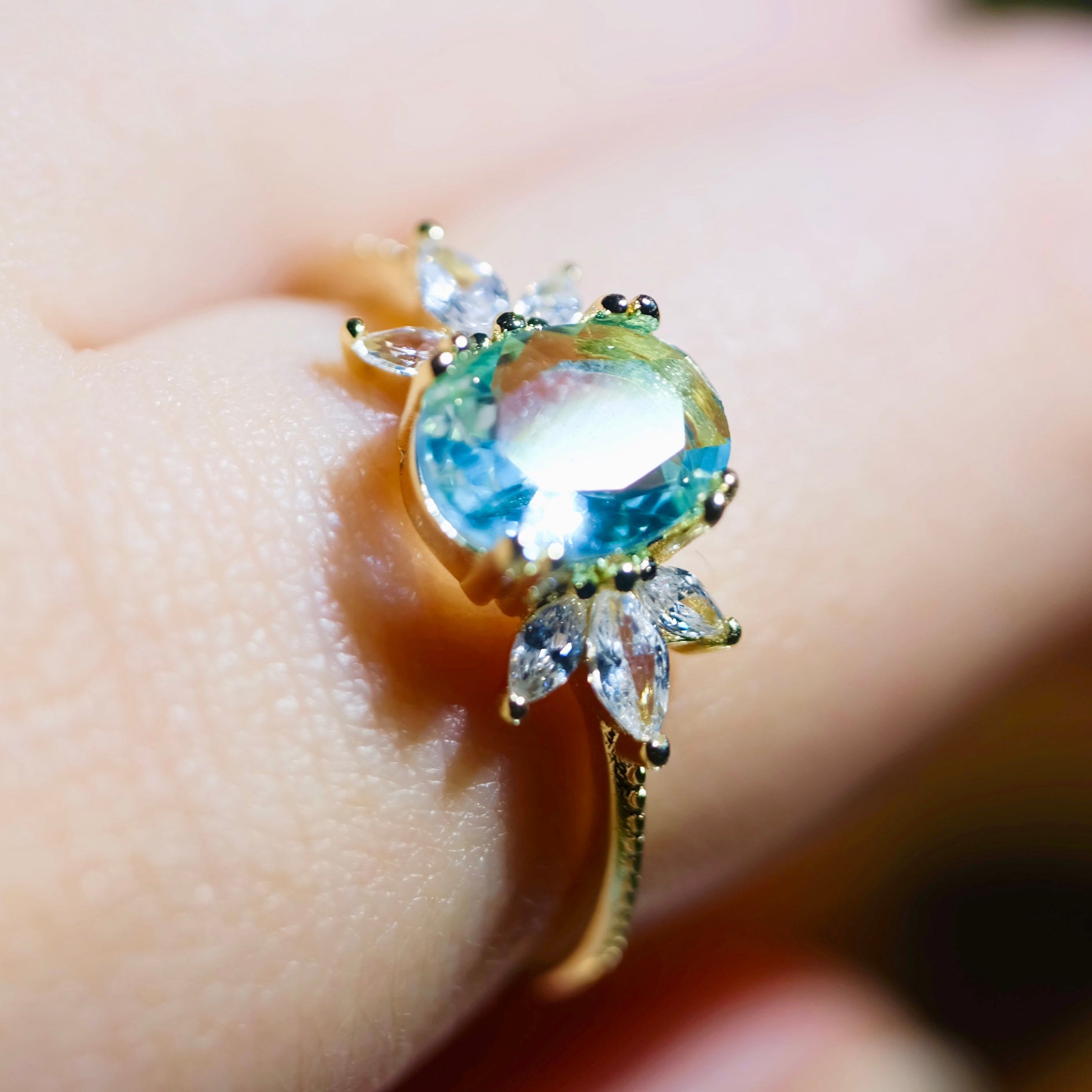 Adjustable blue topaz wing ring by STAR WISH featuring a detailed silver band and a vibrant blue topaz gemstone.