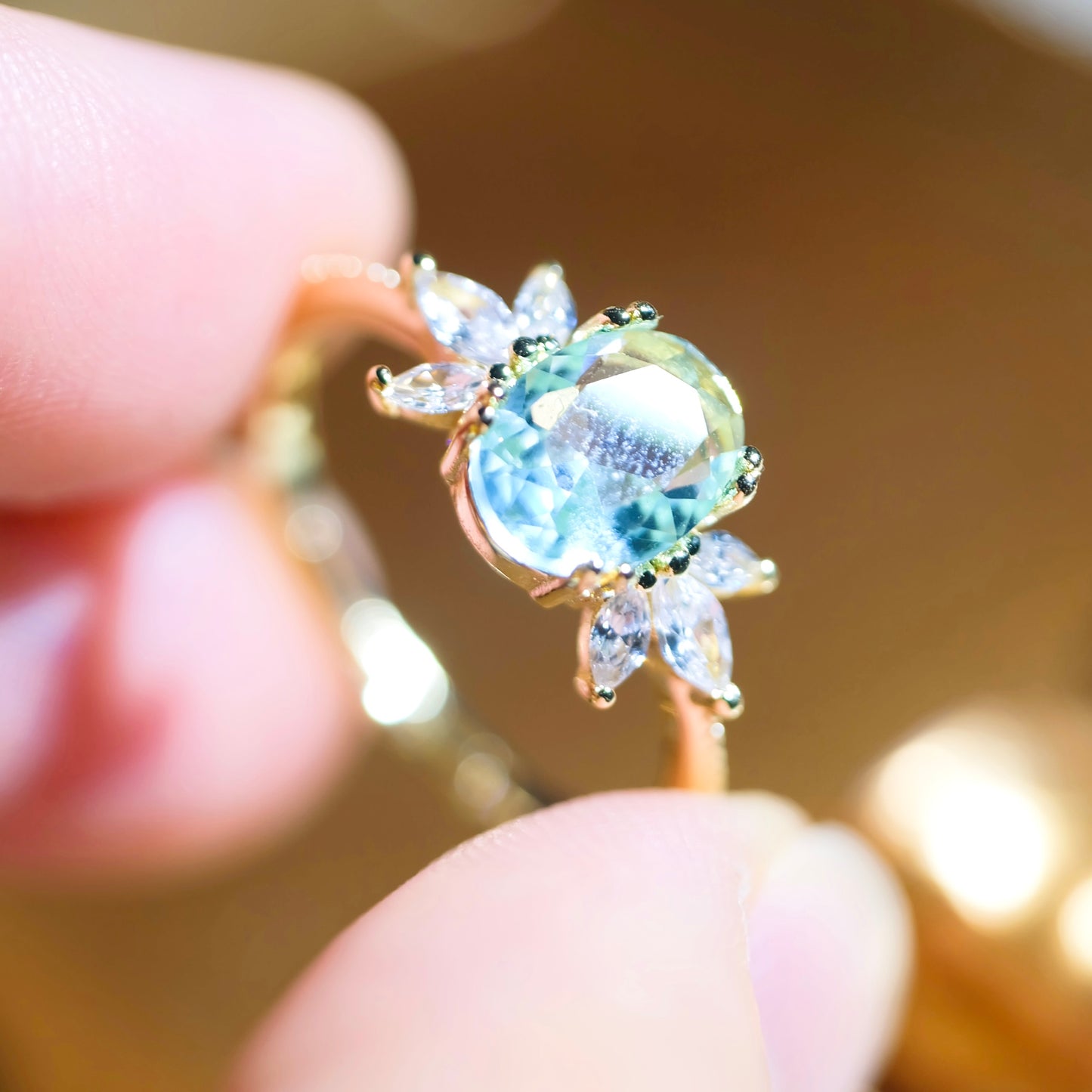 Adjustable blue topaz wing ring from STAR WISH, featuring a sterling silver band with detailed wing design and vibrant blue gemstone.
