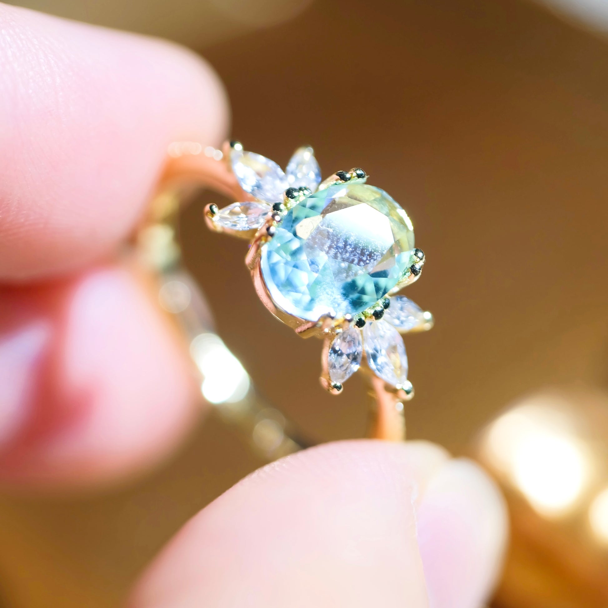 Adjustable blue topaz wing ring from STAR WISH, featuring a sterling silver band with detailed wing design and vibrant blue gemstone.