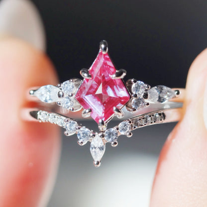 purple alexandrite ring sets held between fingers 