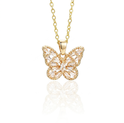Gold butterfly necklace with clear gemstones on a white background