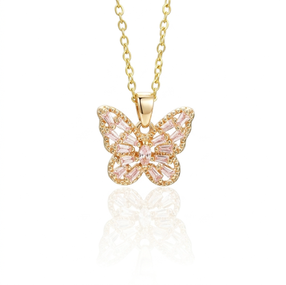 Gold butterfly necklace with pink gemstones on a white background