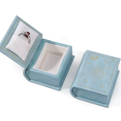 Sky blue book-style jewelry box with moon and stars design 