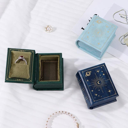 green, blue and sky blue book-style jewelry boxes with moon and stars design