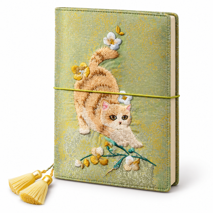 Playful cat and floral embroidery on a green-and-gold A5 journal with tassel bookmark