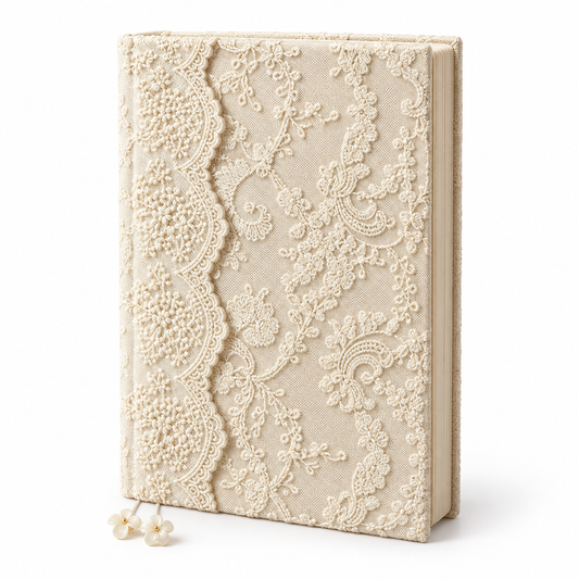 Closed ivory floral lace journal standing upright on white with two flower bookmarks