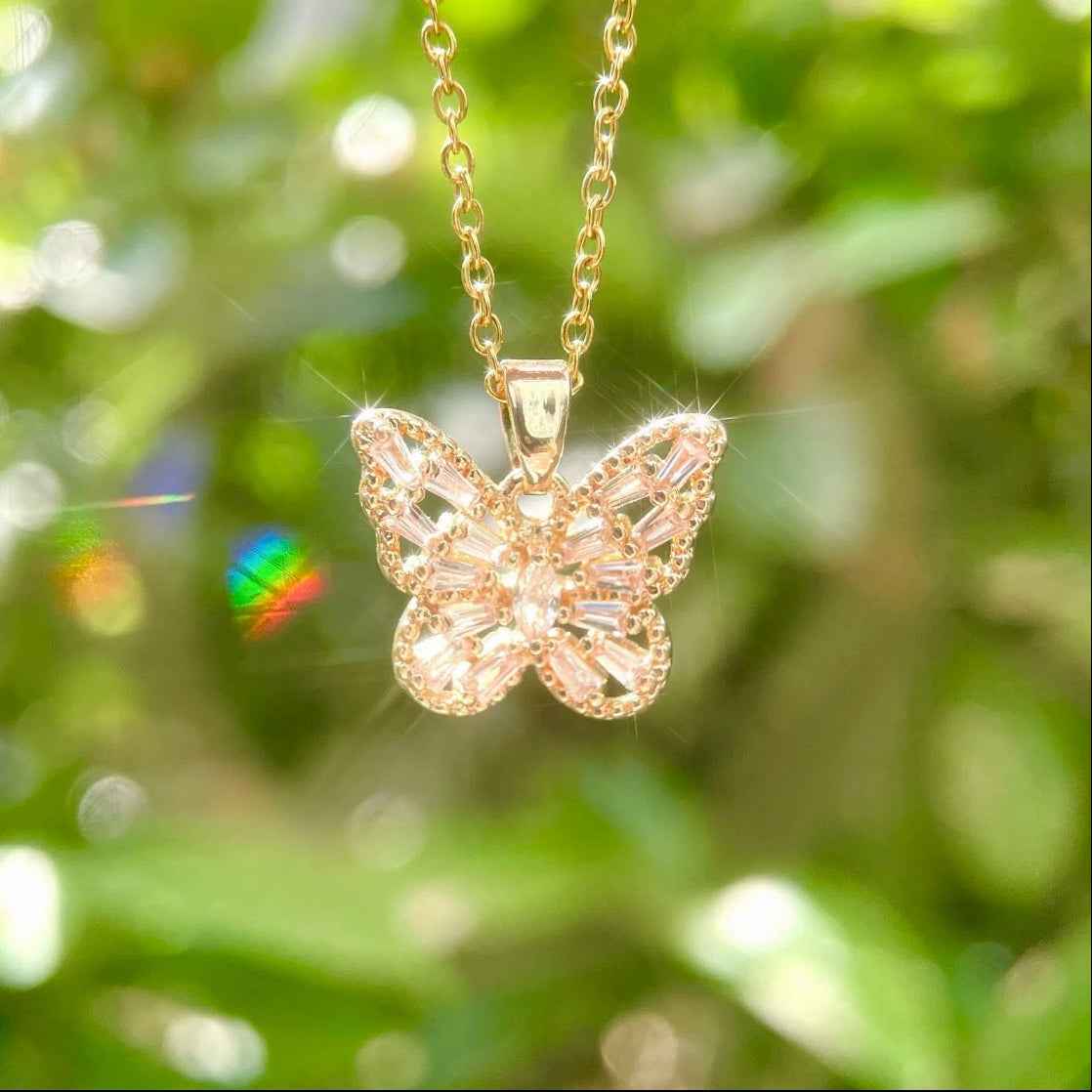 STAR WISH butterfly necklace in pink purple and white shown as lifestyle jewelry photo