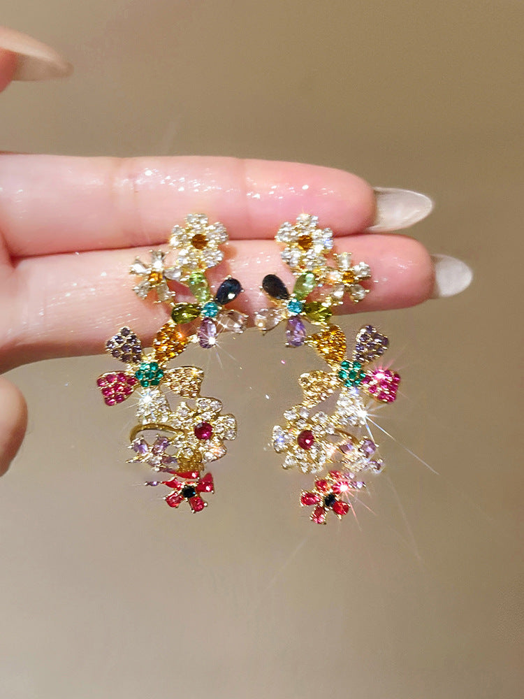 STAR WISH floral tassel stud earrings handheld detail view