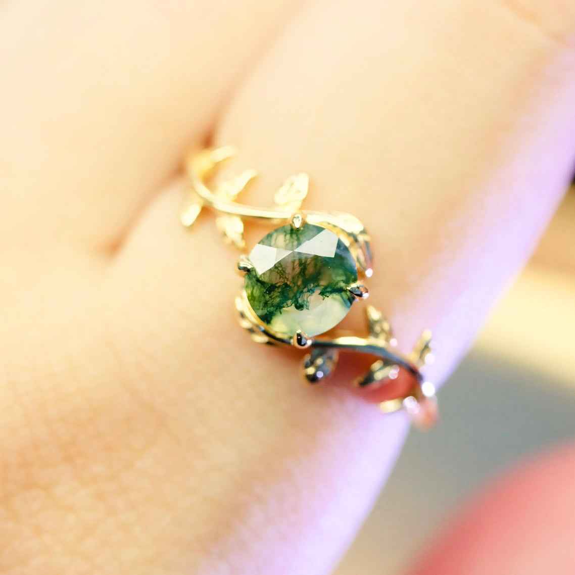 Detail view of STAR WISH gold plated moss agate leaf ring