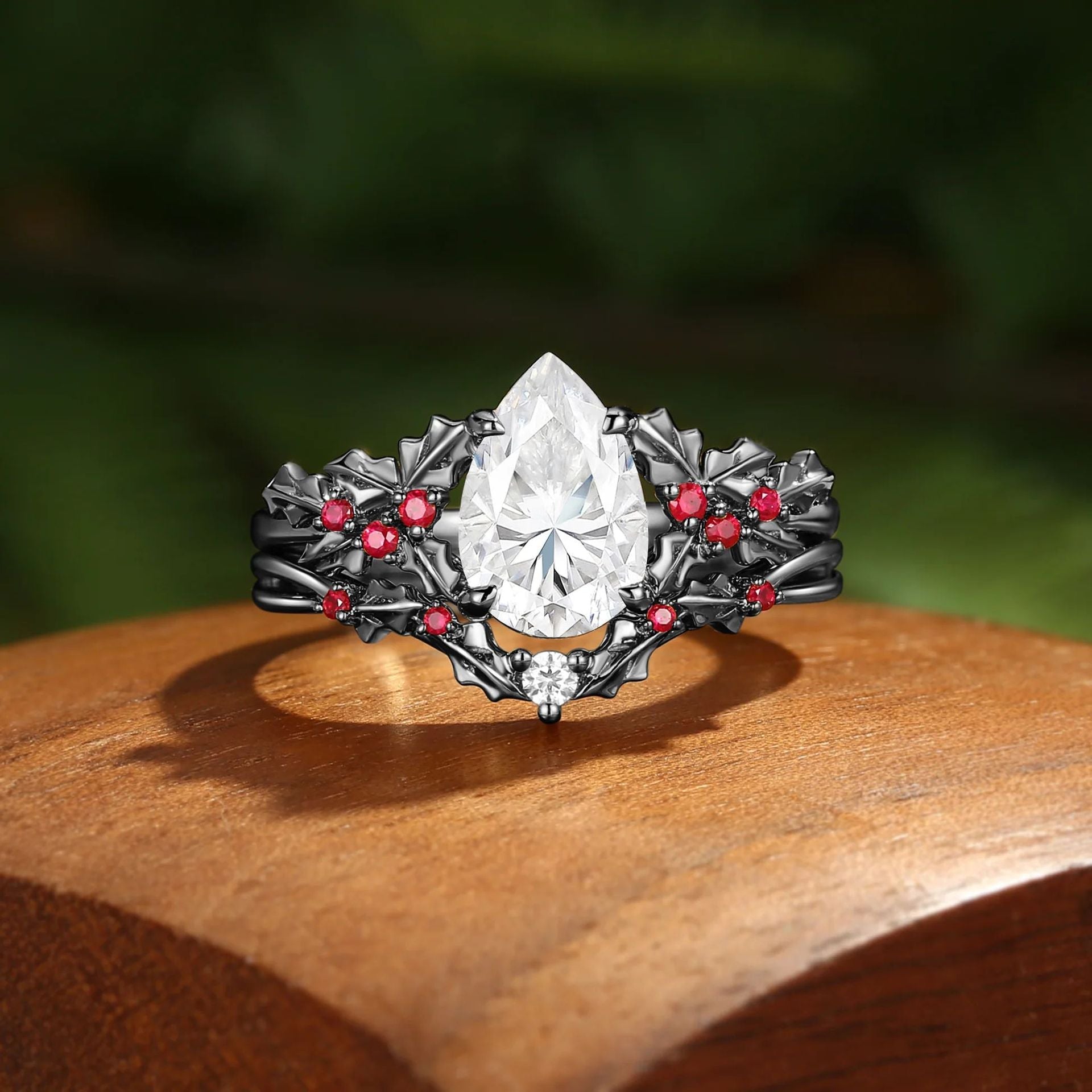 Pear-cut moissanite leaf ring set in dark metal finish