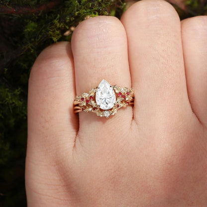 Pear-cut moissanite leaf ring set shown on hand