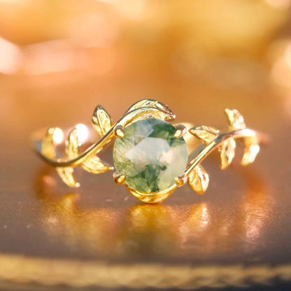 STAR WISH natural moss agate leaf ring shown on hand