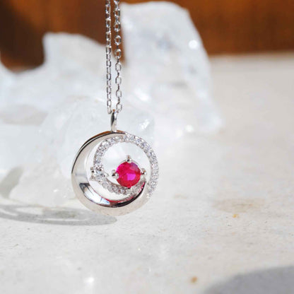Side view of STAR WISH red zircon moon and star necklace