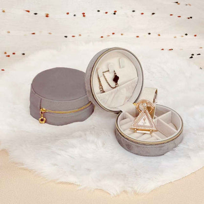 Flat lay of round velvet travel jewelry case organizer