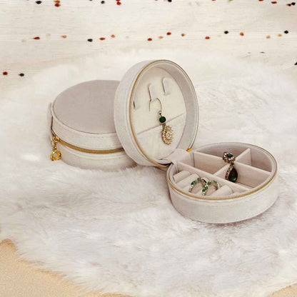 Interior compartments of round velvet travel jewelry organizer