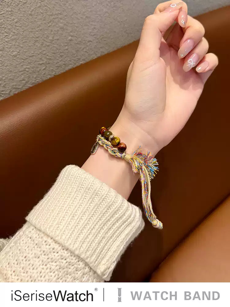 Multicolor woven Apple Watch band worn on wrist
