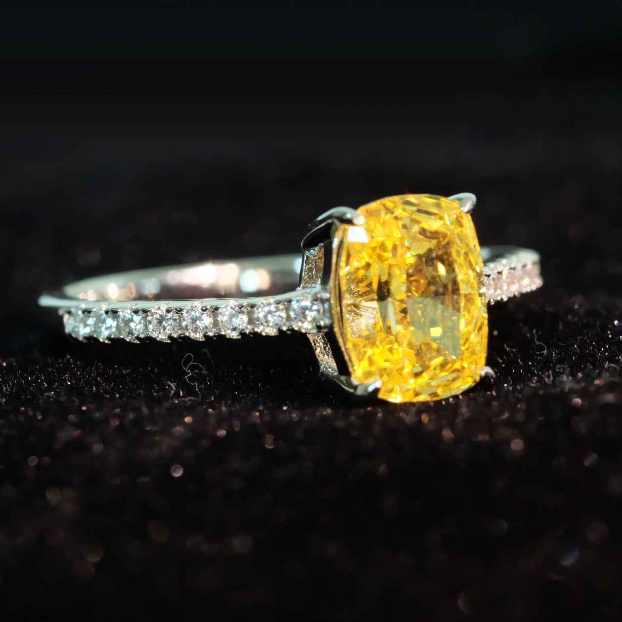 Angled view of yellow zircon ring with rose detailing